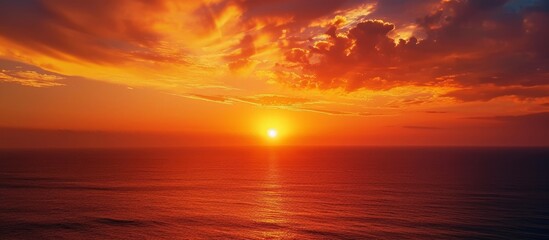 Bright landscape with an orange sunrise in the morning, the sky above the sea forms a vertical sunset.