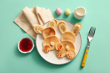 Funny Easter bunny pancakes with banana on turquoise background