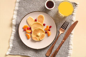 Funny Easter bunny pancakes mandarin and berries on beige background