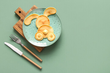 Funny Easter bunny pancakes on green background