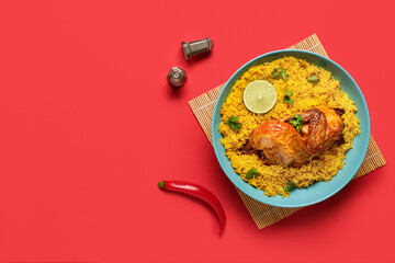 Bowl of traditional chicken biryani on red background