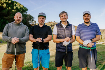 Sotogrante, Spain - January 25, 2024 - Four men with golf clubs, standing on a course, looking at...