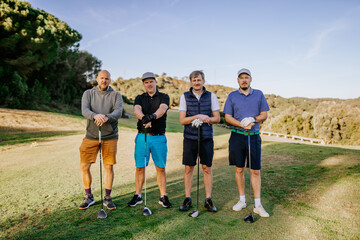 Sotogrante, Spain - January 25, 2024 - Four men with golf clubs on a course, dressed in casual golf...