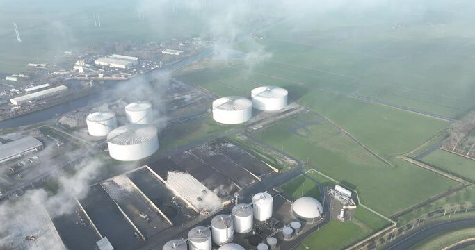 Sugar beet processing factory. Smoke stacks in the agricultural business. Harvested sugar beets processed into foods. Trucks processing raw materials for the sugar factory.