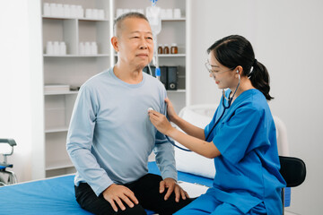 Senior Doctor discussing treatment with male patient talking and laughing sitting on examination bed