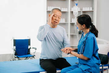 Obraz premium Asian female hands touching senior male hand Helping hands take care of the elderly concept