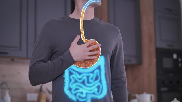 A Man Holds on to his Chest. Stomach and Large Intestine are Hurting. Acid in the Esophagus. Concept of Heartburn
