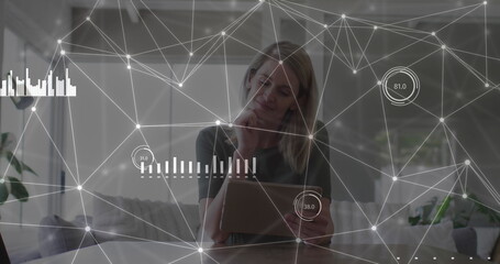 Image of network of connections with data over caucasian businesswoman with tablet
