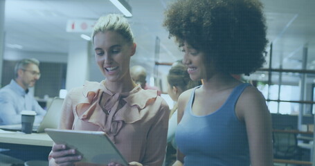 Diverse businesswomen working in office