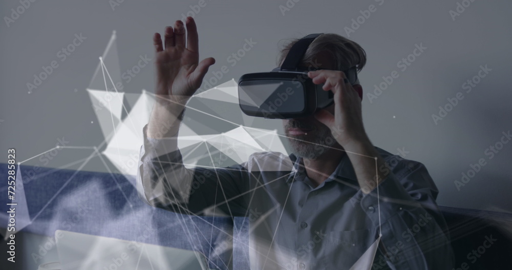 Poster image of connections and data processing over caucasian businessman using vr headset in office