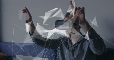 Image of connections and data processing over caucasian businessman using vr headset in office