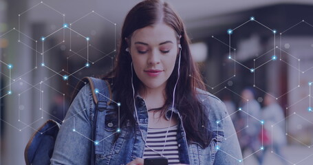 Image of network of connections over caucasian woman using smartphone