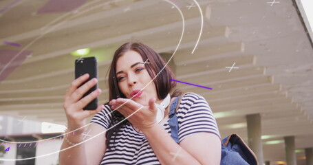 Image of data processing over caucasian woman using smartphone
