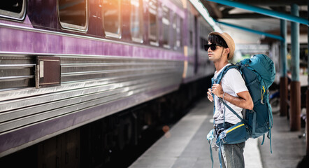 Traveler waits train at train station for travel in summer