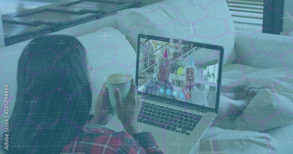 Poster image of network of hexagons over woman using laptop on image call in background