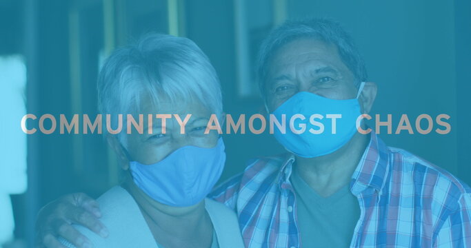 Image of covid 19 text over senior couple embracing wearing face masks - Powered by Adobe