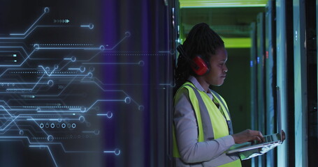 Image of integrated circuits over african american woman working in server room
