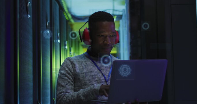 Image of processing circles over african american man working in server room