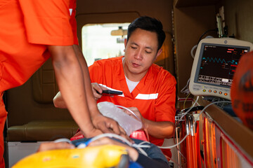 The rescue team is administering CPR to a patient who was involved in an ambulance accident.