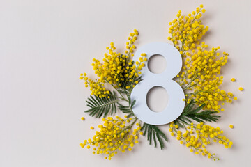 8 March celebration with number eight decorated with spring mimosa flowers top view. Happy Women...