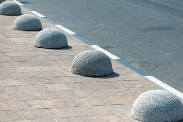 Concrete balls as limiters for parking cars on the road