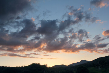 cloud and vanilla sky background with dark mountain silhouette