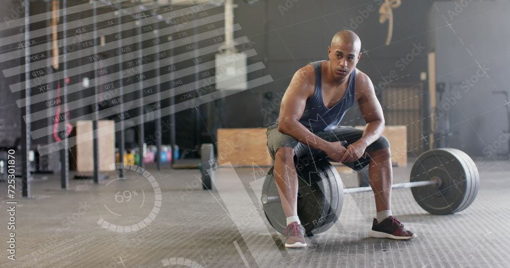Poster image of data processing on interface over biracial man sitting on barbell weights at gym