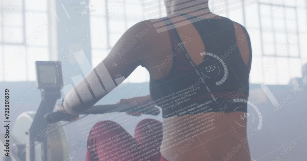 Poster image of data processing on interface over biracial woman training on rowing machine at gym