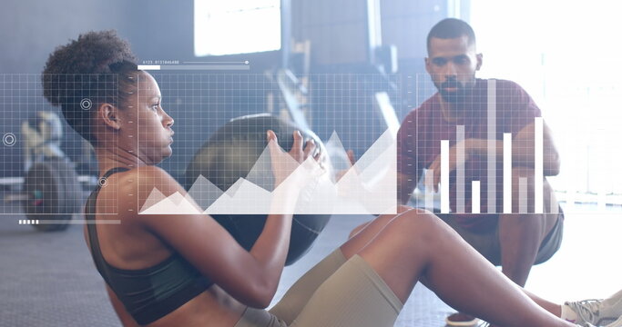 Image of interface over african american male instructor and woman using medicine ball at gym