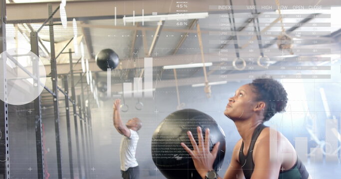 Image of data on interface over african american woman cross training with medicine ball at gym