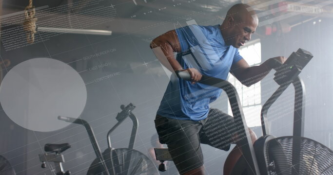 Image of data on interface over african american man cross training on elliptical at gym