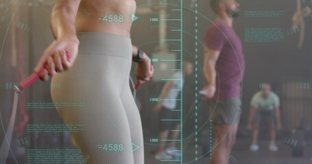 Image of data processing over diverse woman and man jumping rope cross training at gym