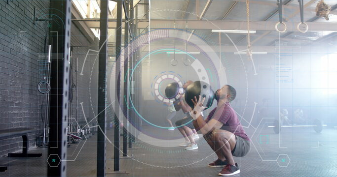 Image of scanner processing data over diverse men throwing medicine balls cross training at gym