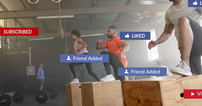 Fototapeta Image of social media notifications over diverse group training on boxes at gym