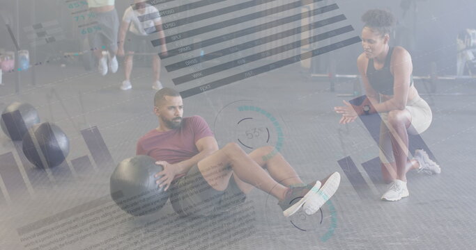 Image of interface processing over diverse female trainer and man using medicine ball at gym - Powered by Adobe