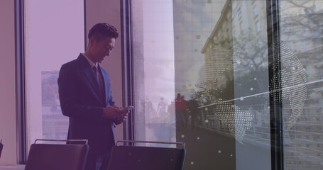 Image of asian businessman using smartphone over data processing and cityscape