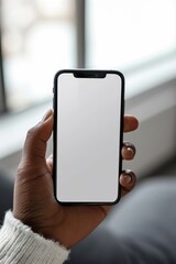 Mockup image of a hand holding a smartphone with blank screen