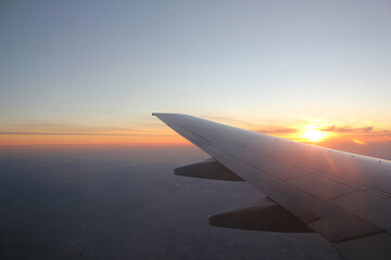 Wing of an airplane in the sunset