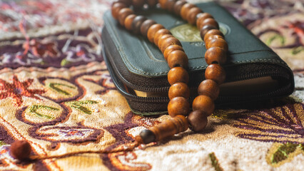 Wooden prayer beads and Holy Book for religion concept