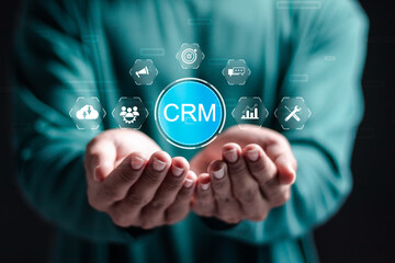 CRM Customer Relationship Management concept. businessman hold virtual CRM icon for customer network management and development of customer information exchange, social media, digital online.