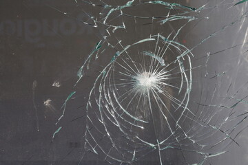 crashed glass  impact ,  window shatterd by gunshot - obrazy, fototapety, plakaty