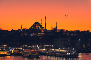 Suleymaniye Mosque and view of the Golden Horn bay at night in Istanbul, Turkey.