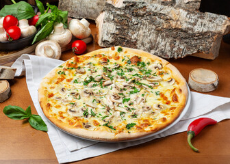 Italian pizza with champignons and cheese on a wooden background