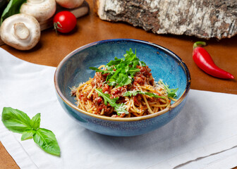 Bolognese pasta in a plate on a wooden background