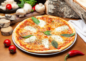 Pizza Margherita with basil, mozzarella cheese and tomato