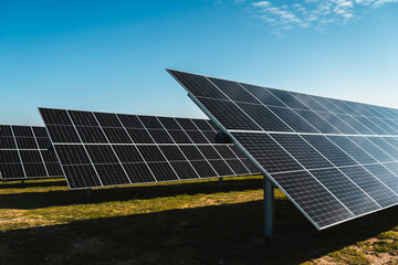 solar panels under blue sky, in new solar photovoltaic plant, bright sunny day