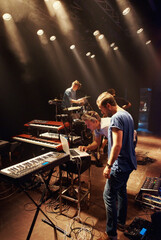 Electric, keyboard and musician at stage with band for preparation of production for concert....