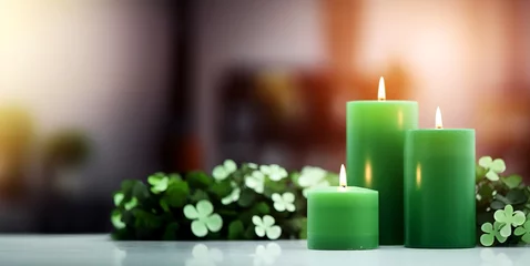 Fotobehang An arrangement of green candles and shamrock decor, St. Patrick’s Day, blurred background, with copy space © Iryna