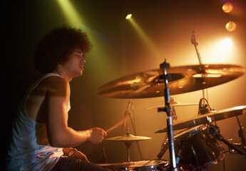 Stage, performance and man on drums at concert playing jazz, beat and talent for music. Drummer,...