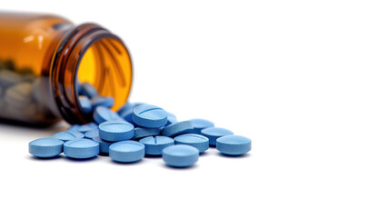 Blue medical pills or tablets with bottle on white background